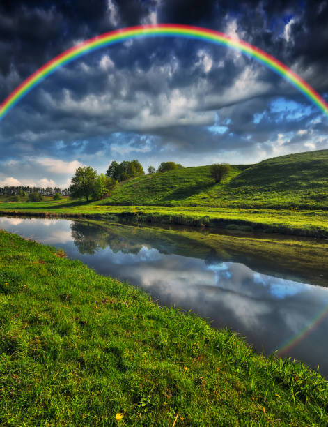 istock Landscape with a Rainbow on the River in Spring. colorful morning 1297915920