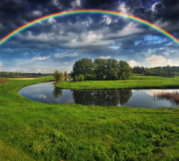 istock Landscape with a Rainbow on the River in Spring. colorful morning 1297916018
