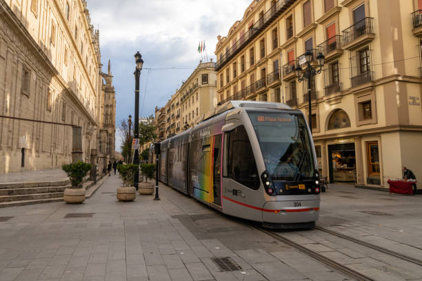 Beautiful city center of Seville with few tourist due the Coronavirus isolation measures. In background the Cathedral of Seville. Tram rails, trams at the station.