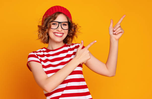istock Cheerful stylish woman pointing away 1297922031