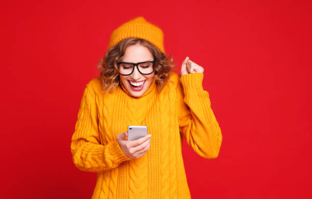 istock Excited female reading message on smartphone 1297922424