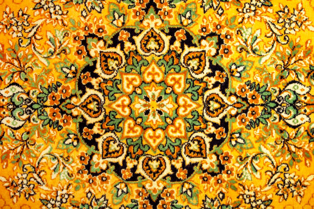 istock Fragment of an old Russian carpet. Crafted from a heavy, fleecy patterned fabric. View from the front. Brown with yellow. 1297924524