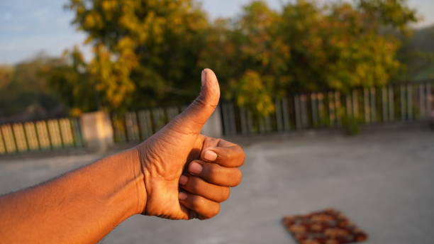 istock Win or Confirmation OK sign with hands thumb up with attractive green background. 1297925214