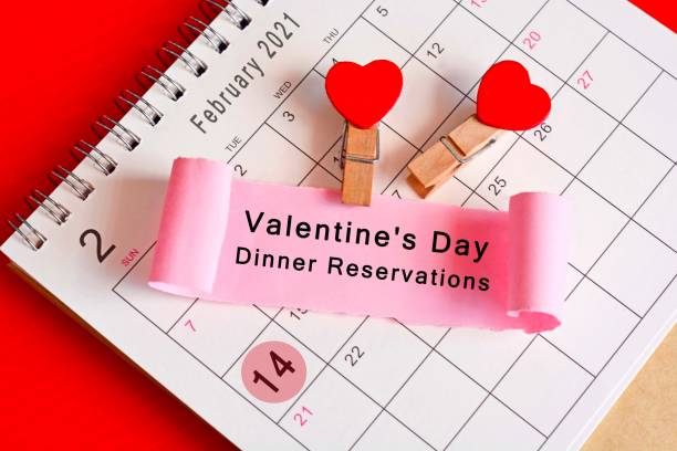 istock Torn paper on February calendar 2021 with phase - Valentine's Day Dinner Reservations. Valentine's Day Concept 1297928189