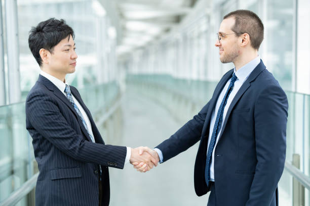 istock Two business people shaking hands 1297928999