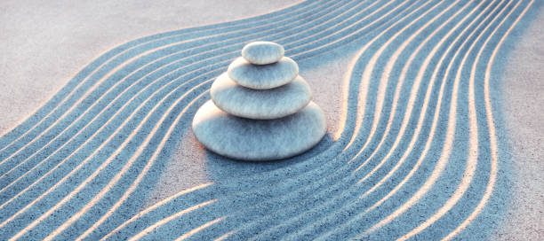 istock Japanese ZEN garden with textured sand waves and stack of stones 1297929339