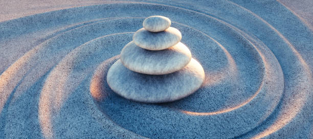 istock Japanese ZEN garden with textured sand waves and stack of stones 1297929402