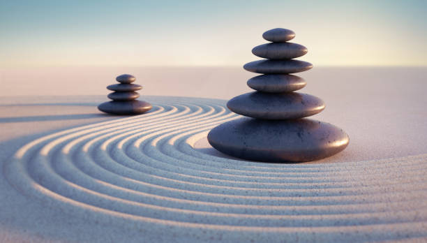 istock Japanese ZEN garden with textured sand waves and stack of stones 1297929417