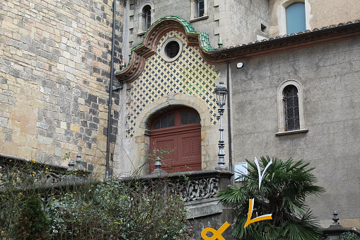 Olot, Spain – January 1, 2021: Portalada lateral de Sant Esteve in Olot, Catalonia. This one of the secondary entrances to Sant Esteve Church.