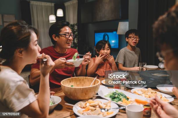 Asian Chinese Family And Cousins Having Reunion Dinner At Home Stock Photo - Download Image Now