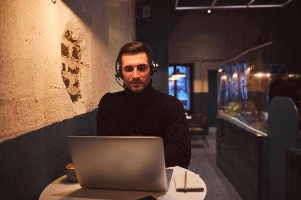 istock Cheerful man during video call in cafe 1297931751