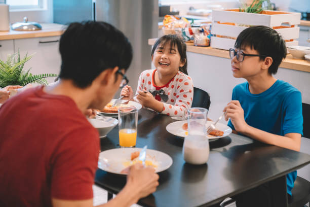 istock asian chinese siblings having western breakfast with family at kitchen 1297932253