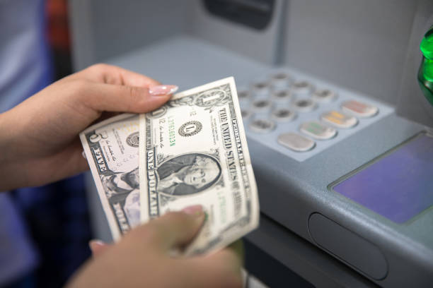istock Woman hand showing dollar banknotes 1297933198