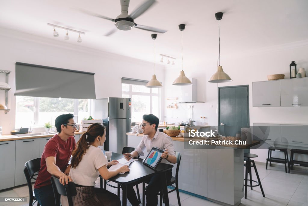 asian chinese couple consulting with an insurance agent in her house businessman with client Financial Advisor Stock Photo
