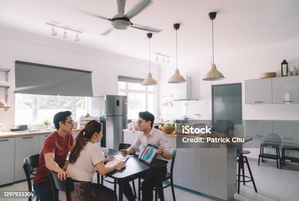 Asian Chinese Couple Consulting With An Insurance Agent In Her House Stock Photo - Download Image Now