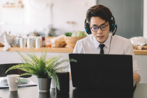 istock asian chinese businessman working from home as customer support communicating with client via video conference 1297933328