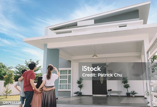 istock asian chinese family looking at their new house with their daughter and son 1297933338