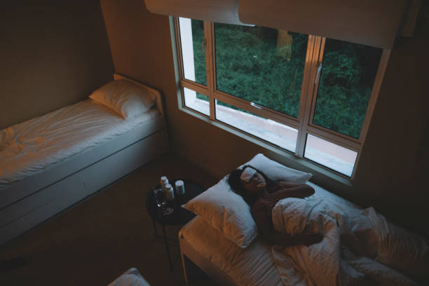 istock sick asian chinese daughter  with fever patch sleeping at bedroom 1297933369