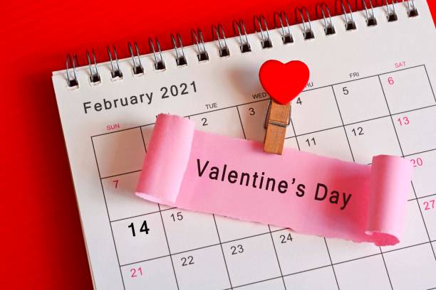 istock Torn paper on February calendar 2021 with phase - Valentine's Day 1297933650