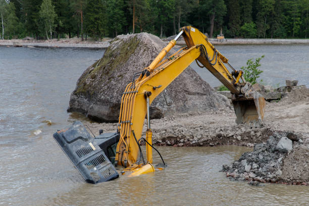 istock Excavator drowned on the lake while working to strengthen shore 1297933698