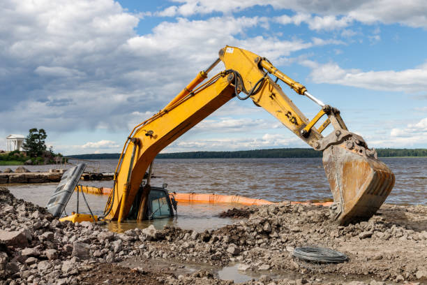 istock Excavator drowned on the lake while working to strengthen the shore 1297933701