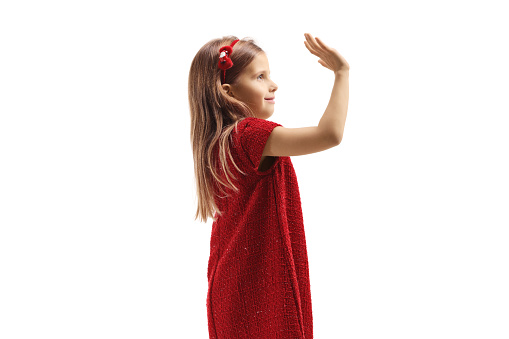 Girl in a red dress greeting with hand isolated on white background