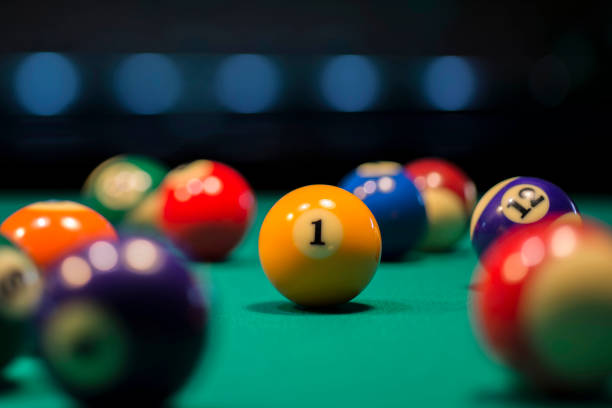 istock American pool ball number one on a pool table 1297935829