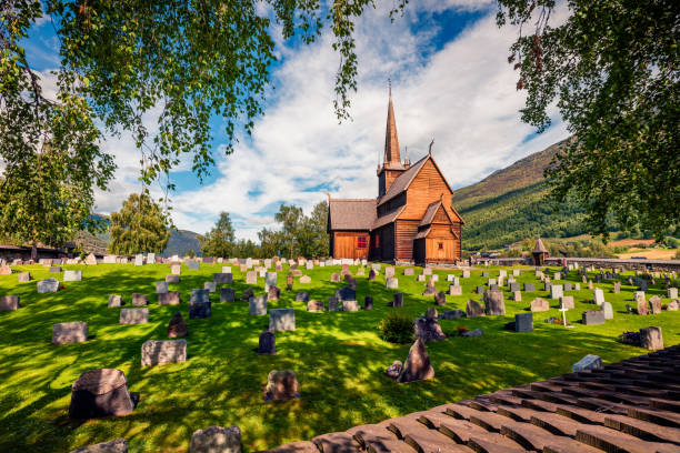 Picturesque summer view of Lom stave church (Lom Stavkyrkje). Sunny morning scene of Norwegian countryside, administrative centre of Lom municipality - Fossbergom, Norway, Europe. stock photo