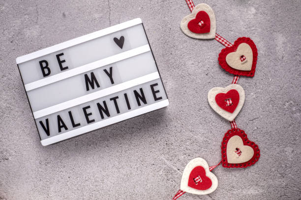 istock Be my Valentine light box with felt hearts decor on cement background 1297937020