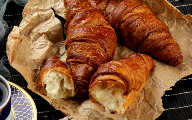 istock fresh croissants with a cup of coffee 1297937023
