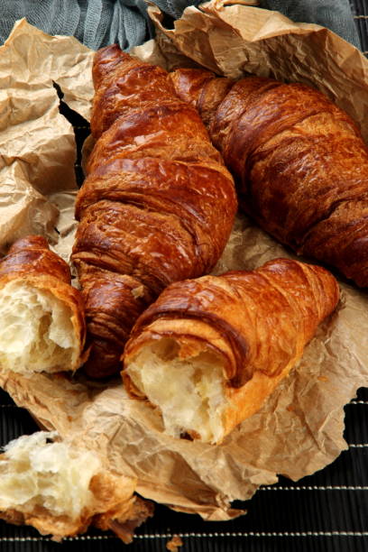 istock fresh croissants with a cup of coffee 1297937027