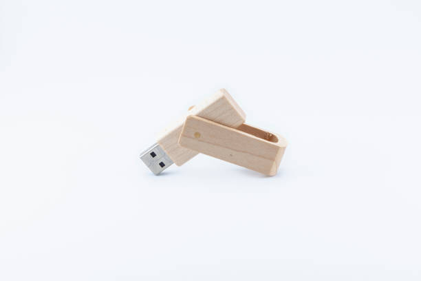 Wooden pen drive on white background Wooden pen drive placed on a white background, open at an obtuse angle with the USB connector pointing down. wooden flash drive stock pictures, royalty-free photos & images