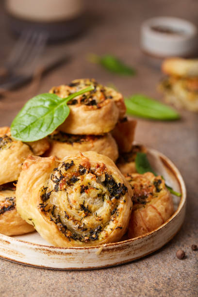 istock Puff pastry Pizza rolls with spinach, chicken meat and cheese 1297938631