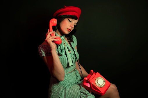 stylish woman and retro phone