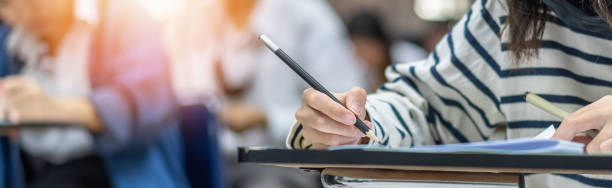 istock Exam at school with student's taking educational admission test in class, thinking hard, writing answer in university classroom, education and world literacy day concept 1297941050