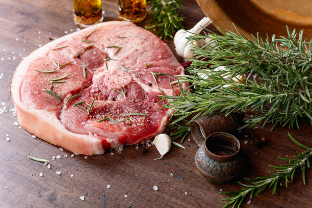 istock Raw pork with rosemary , salt and pepper. 1297941235
