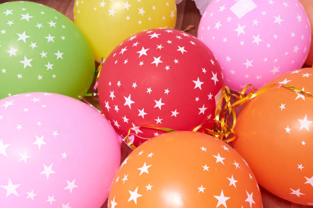 istock many colored balloons with stars forming a bright background wallpaper image. 1297942030
