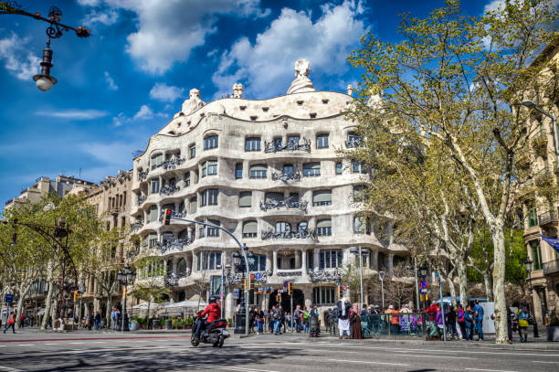 Barcelona, Spain - April 3, 2018: Front view of Casa Mila, also known as La Pedrera, designed by Antonio Gaudi located on Passeig De Gracia.