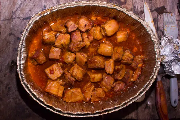 Photo of Pork Belly smoked on the Pit Smoker grill and seasoned with Dry Rub. Rustic food. Top Photograph.