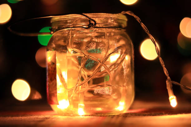 istock Transparent jar with led lights inside and Bokeh lights in background. Home decoration 1297942752