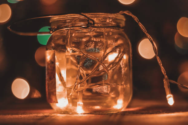 istock Transparent jar with led lights inside and Bokeh lights in background. Home decoration 1297942754