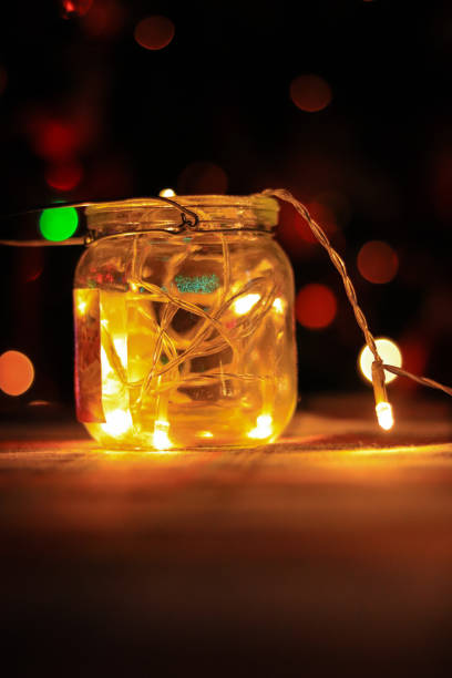 istock Transparent jar with led lights inside and Bokeh lights in background. Home decoration 1297942756