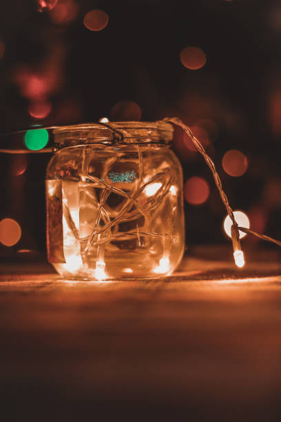 istock Transparent jar with led lights inside and Bokeh lights in background. Home decoration 1297942757