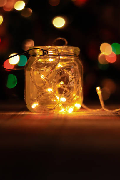 istock Transparent jar with led lights inside and Bokeh lights in background. Home decoration 1297942758