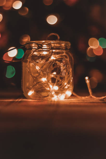 istock Transparent jar with led lights inside and Bokeh lights in background. Home decoration 1297942759