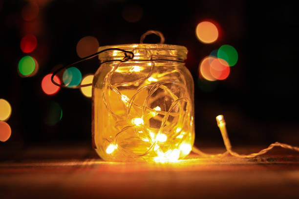 istock Transparent jar with led lights inside and Bokeh lights in background. Home decoration 1297942763
