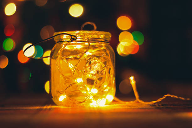 istock Transparent jar with led lights inside and Bokeh lights in background. Home decoration 1297942765