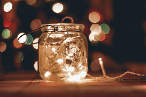 istock Transparent jar with led lights inside and Bokeh lights in background. Home decoration 1297942766
