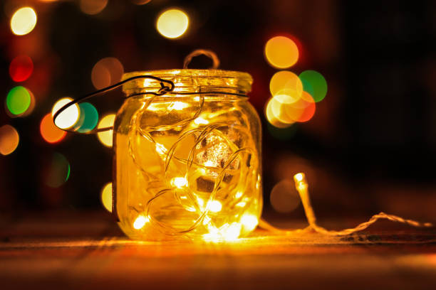 istock Transparent jar with led lights inside and Bokeh lights in background. Home decoration 1297942772