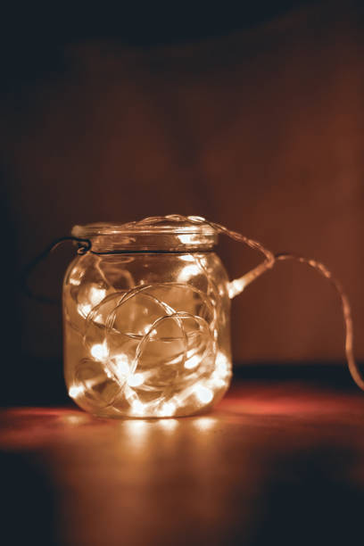 istock Transparent jar with led lights inside and Bokeh lights in background. Home decoration 1297942773